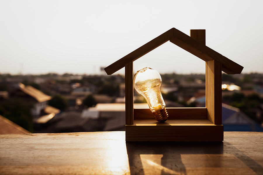 lightbulb-leaning-against-wooden-house-model-granbury-tx